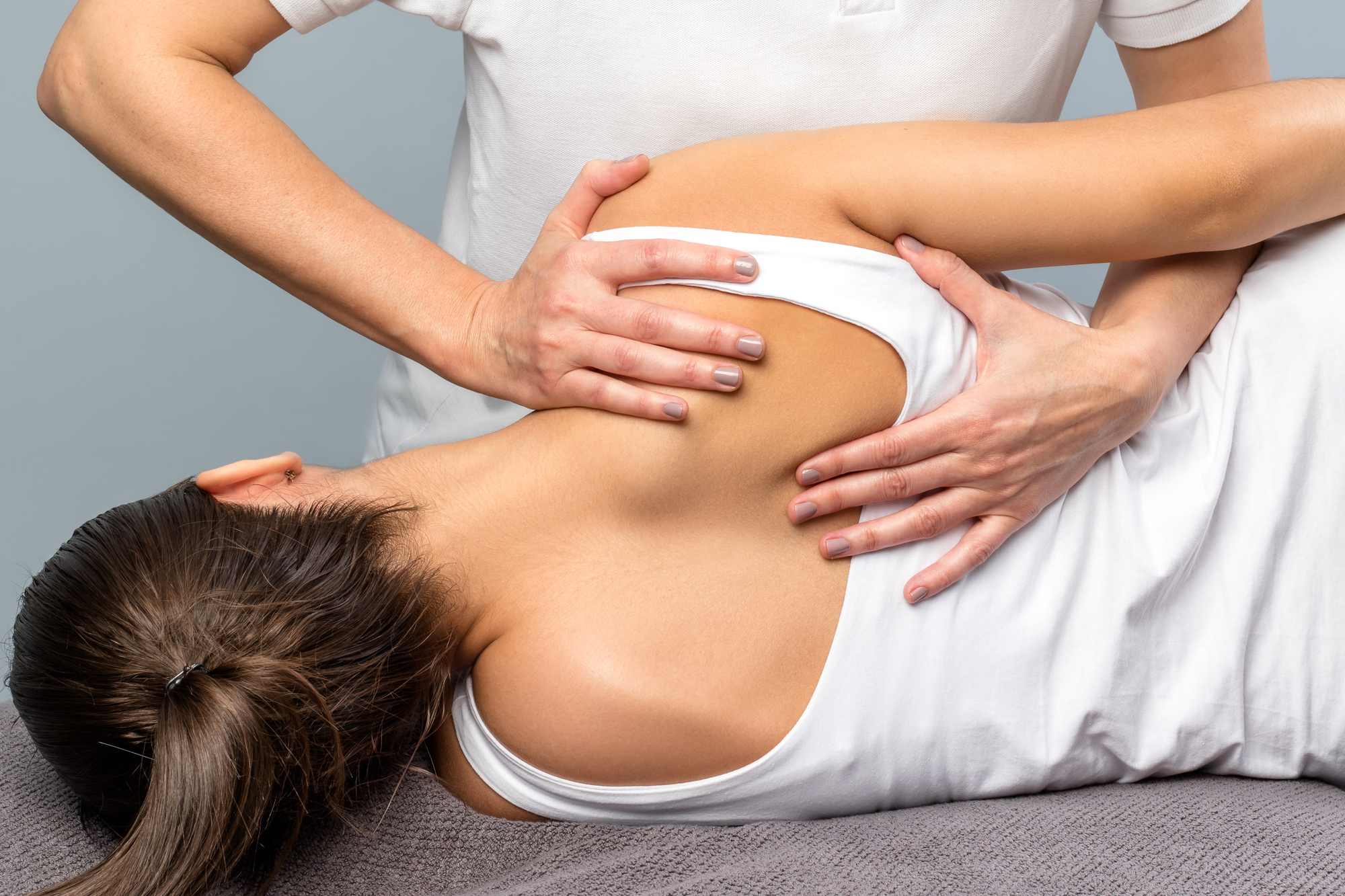 Back Pain Doctor Bethesda, MD with a a chiropractor adjusting a woman's back